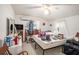 A bedroom with natural lighting, simple decor, a fan, and window with thin white curtains at 3115 W Wyoming Ave, Tampa, FL 33611