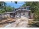Two-story home with blue siding, a covered porch, and a one-car garage at 3115 W Wyoming Ave, Tampa, FL 33611
