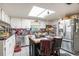 Functional kitchen with white cabinets, black countertops, and stainless steel appliances at 3115 W Wyoming Ave, Tampa, FL 33611