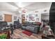 Comfortable living room featuring a dark leather sofa and views of the kitchen at 3115 W Wyoming Ave, Tampa, FL 33611