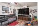 Open living room with wood laminate flooring and view to the staircase and kitchen at 3115 W Wyoming Ave, Tampa, FL 33611