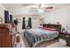 Main bedroom with dark curtains, ceiling fan, and carpeted floors at 3115 W Wyoming Ave, Tampa, FL 33611