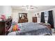 Primary bedroom featuring dresser with mirror, ceiling fan, and natural light at 3115 W Wyoming Ave, Tampa, FL 33611