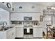 Updated kitchen featuring white cabinets, stainless steel appliances, and a mosaic tile backsplash at 3139 Pine Top Dr, Valrico, FL 33594