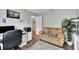 Functional office space featuring a couch, desk, printer, white shelving and natural light at 3139 Pine Top Dr, Valrico, FL 33594