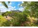 The property's private backyard, including the screened in lanai, pond and surrounding landscaping at 3254 Grassglen Pl, Wesley Chapel, FL 33544