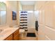 Cozy bathroom with a single vanity, toilet, and shower with a striped curtain at 3254 Grassglen Pl, Wesley Chapel, FL 33544