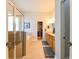 A bathroom with a double vanity, glass-enclosed shower, soaking tub, and a walk-in closet at 3254 Grassglen Pl, Wesley Chapel, FL 33544