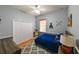 This bedroom features a blue bed, fan, and train decorations at 3254 Grassglen Pl, Wesley Chapel, FL 33544