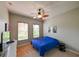 Inviting bedroom with two windows, a ceiling fan, and neutral decor at 3254 Grassglen Pl, Wesley Chapel, FL 33544