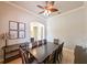 Elegant dining room with seating for eight, designer lighting, and stylish decor with wall art at 3254 Grassglen Pl, Wesley Chapel, FL 33544