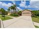Landscaped single-story home with a wide driveway, neutral paint and desert landscaping at 3254 Grassglen Pl, Wesley Chapel, FL 33544