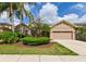 Charming single-story home with manicured front lawn, mature landscaping, and two-car garage in a desirable neighborhood at 3254 Grassglen Pl, Wesley Chapel, FL 33544