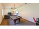 Spacious game room with pool table, comfortable seating, and neutral walls at 3254 Grassglen Pl, Wesley Chapel, FL 33544
