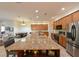 Open concept kitchen features granite countertops, stainless steel appliances, and breakfast bar at 3254 Grassglen Pl, Wesley Chapel, FL 33544