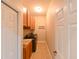 Well-equipped laundry room with washer, dryer, sink, and cabinet storage at 3254 Grassglen Pl, Wesley Chapel, FL 33544