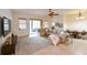 Bright living room with comfortable sectional, neutral tones and sliding glass doors at 3254 Grassglen Pl, Wesley Chapel, FL 33544