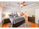 Cozy primary bedroom with neutral walls, ceiling fan, stylish furniture, and ensuite bathroom at 3254 Grassglen Pl, Wesley Chapel, FL 33544