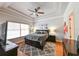 Cozy main bedroom boasting tray ceilings, a ceiling fan, large window, and a restful ambiance at 3254 Grassglen Pl, Wesley Chapel, FL 33544