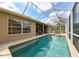 Spacious screened-in pool with covered patio, lush landscaping and great natural light at 3254 Grassglen Pl, Wesley Chapel, FL 33544