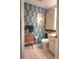 Bathroom featuring tropical leaf wallpaper, vintage radio, and white tiled floors at 3306 Lacewood Rd, Tampa, FL 33618