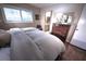 Bedroom with hardwood floors, neutral linens, and a traditional wood dresser at 3306 Lacewood Rd, Tampa, FL 33618