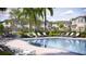 Community pool offers lounge chairs, tables, and umbrellas for relaxing outside the townhomes at 36067 Joseph Blake St, Zephyrhills, FL 33541