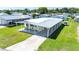 Overhead view of a single-story home with carport, highlighting the property's surroundings in a community setting at 36848 Beth Ave, Zephyrhills, FL 33542