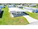 Aerial view of property, showcasing its carport, landscaping, and position within a community of similar homes at 36848 Beth Ave, Zephyrhills, FL 33542