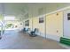 Comfortable covered patio with seating, offering a relaxing outdoor space with views of the surrounding community at 36848 Beth Ave, Zephyrhills, FL 33542