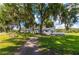 Charming single story home on manicured lawn features a patio, sidewalks and lush landscaping at 36848 Beth Ave, Zephyrhills, FL 33542