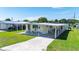 Inviting single-story home with covered parking, showcasing curb appeal, lawn, and welcoming front entrance at 36848 Beth Ave, Zephyrhills, FL 33542