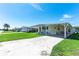 Single-story home with a convenient covered carport, manicured lawn, and welcoming entrance in a friendly community at 36848 Beth Ave, Zephyrhills, FL 33542