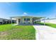 Charming single-story home featuring a covered carport and well-maintained front yard with sunny curb appeal at 36848 Beth Ave, Zephyrhills, FL 33542