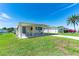 Inviting single-story home showcasing covered entrance, adjacent carport, lawn and comfortable community setting at 36848 Beth Ave, Zephyrhills, FL 33542