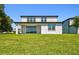 Large backyard, view from the covered patio, features green grass and a view of neighboring homes at 37194 Clinch Cir, Zephyrhills, FL 33540