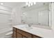 Bathroom featuring a double sink vanity, quartz countertop, tub, and large mirror with modern lighting at 37194 Clinch Cir, Zephyrhills, FL 33540