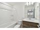 Clean bathroom featuring a shower-tub combo, toilet, and vanity with a granite countertop at 37194 Clinch Cir, Zephyrhills, FL 33540