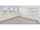 Spacious bedroom with plush carpet and several large windows offering ample natural light at 37194 Clinch Cir, Zephyrhills, FL 33540