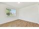 Bedroom with wood-look tile flooring, a window, and neutral walls, ready for personalization at 37194 Clinch Cir, Zephyrhills, FL 33540