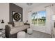 Cozy bedroom with a daybed, soft lighting, a comfortable ottoman, and a view of the outdoors at 37194 Clinch Cir, Zephyrhills, FL 33540