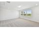 Spacious bedroom with plush carpet and three large windows providing ample natural light at 37194 Clinch Cir, Zephyrhills, FL 33540