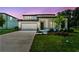 This two-story home has a well-manicured lawn, a two-car garage, and beautiful twilight skies at 37194 Clinch Cir, Zephyrhills, FL 33540