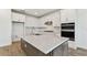 Kitchen featuring quartz counters, undermount sink, stainless appliances, and white cabinets at 37194 Clinch Cir, Zephyrhills, FL 33540