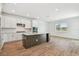 Modern kitchen with a large island featuring white cabinets, stainless steel appliances, and recessed lighting at 37194 Clinch Cir, Zephyrhills, FL 33540