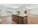 Kitchen island featuring a dishwasher, sink, and ample storage, connecting to the living area at 37194 Clinch Cir, Zephyrhills, FL 33540