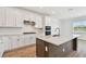 Gourmet kitchen with sleek stainless steel appliances and expansive quartz countertop island at 37194 Clinch Cir, Zephyrhills, FL 33540