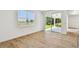 Living room showcasing a view of the backyard, featuring tile floors and natural light at 37194 Clinch Cir, Zephyrhills, FL 33540