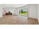 Open-concept living room with kitchen, stainless appliances, and sliding glass door to outdoors at 37194 Clinch Cir, Zephyrhills, FL 33540