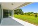Covered patio overlooking a lush green lawn and mature trees, perfect for outdoor relaxation at 37194 Clinch Cir, Zephyrhills, FL 33540